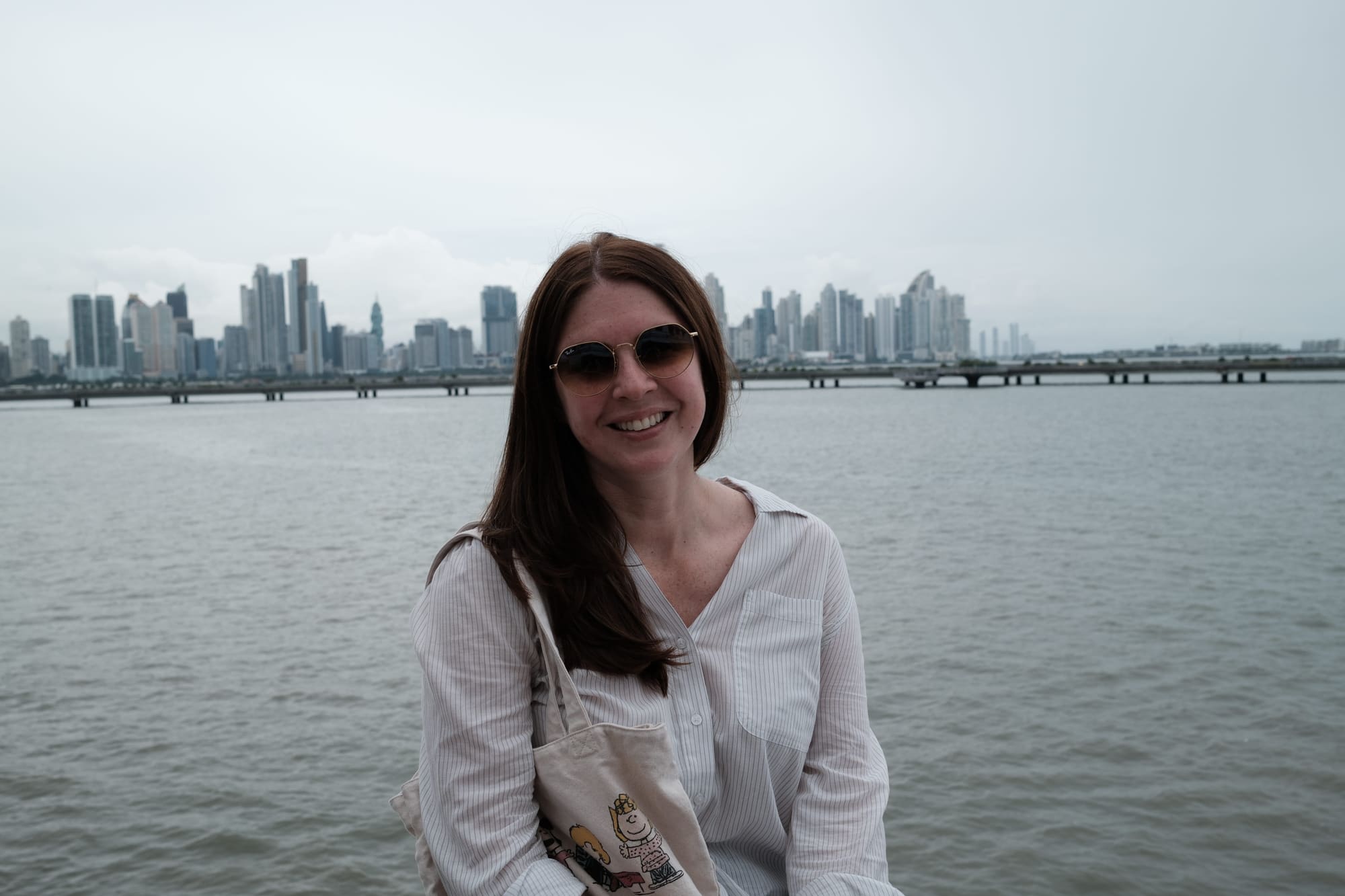 A woman standing with the city in the background in Casco Viejo, Panama