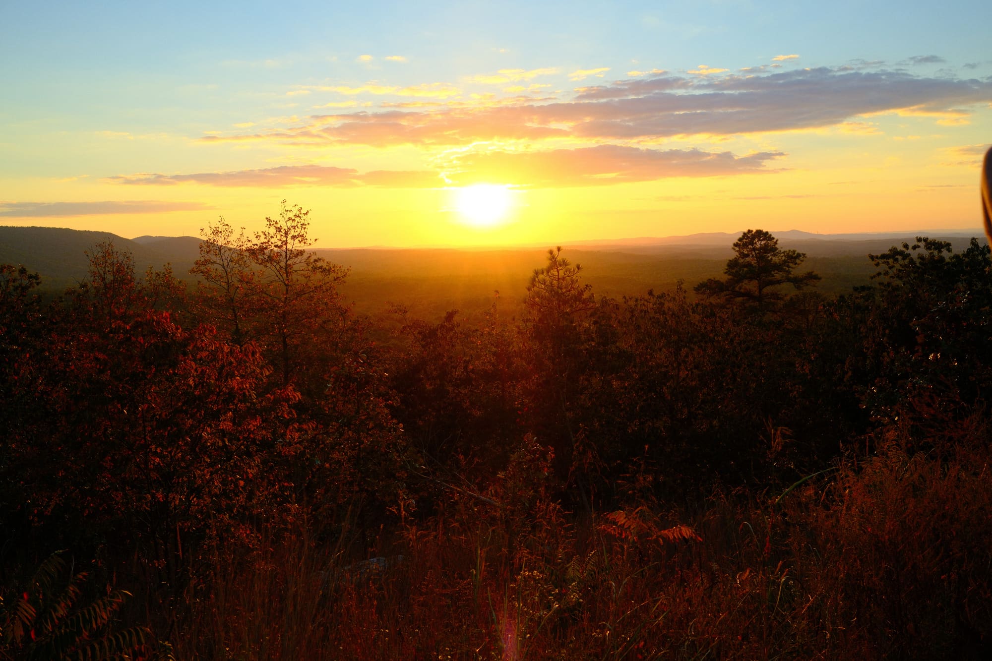 People talking near a sunset in rural Alabama
