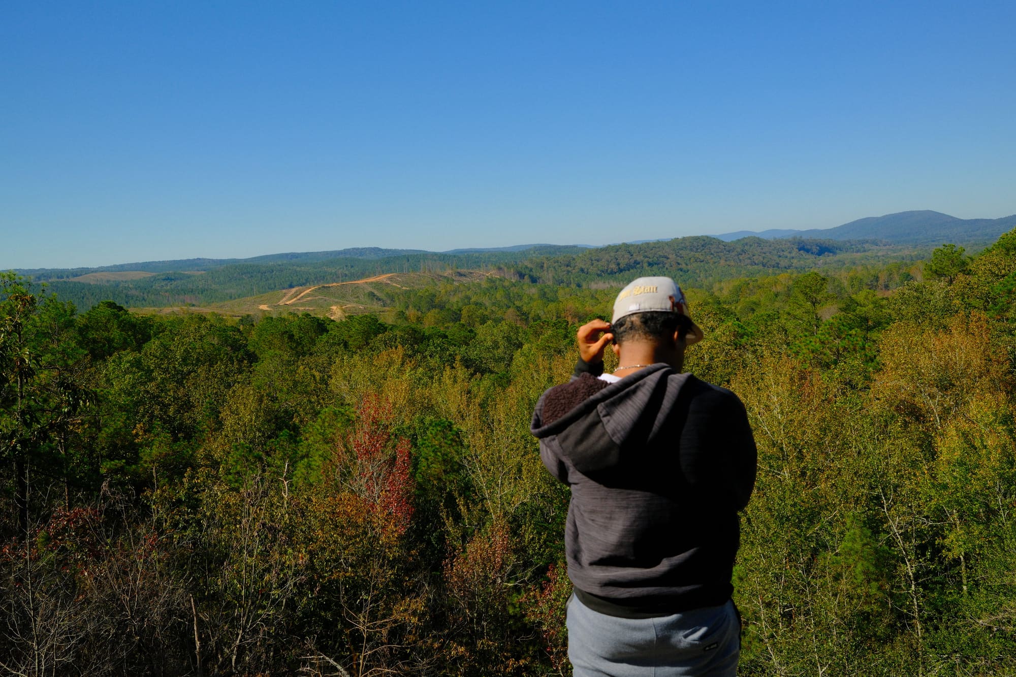 A person standing on a hill in rural Alabama
